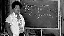 Audre Lorde in front of a blackboard on which it is written "Women are powerful and dangerous" at the Atlantic Center for the Arts, New Smyrna Beach, Florida, 1983. Robert Alexander/Archive Photos/Getty Image